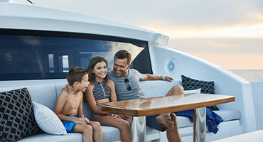 family sitting on yacht