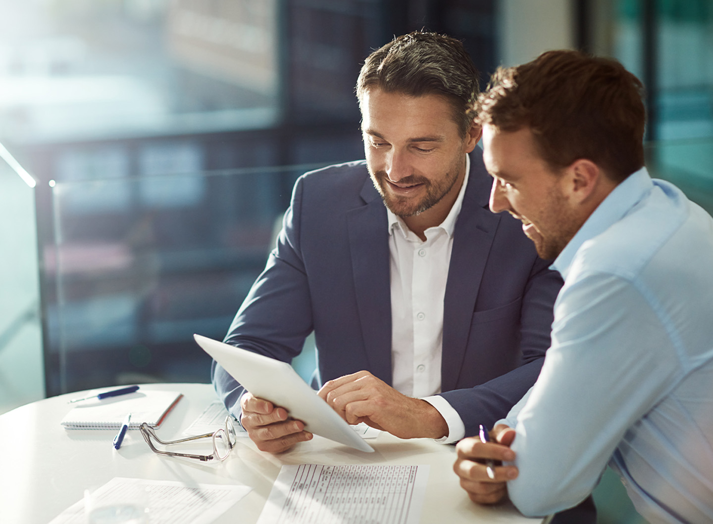 Men dressed in business attire interacting and looking happy