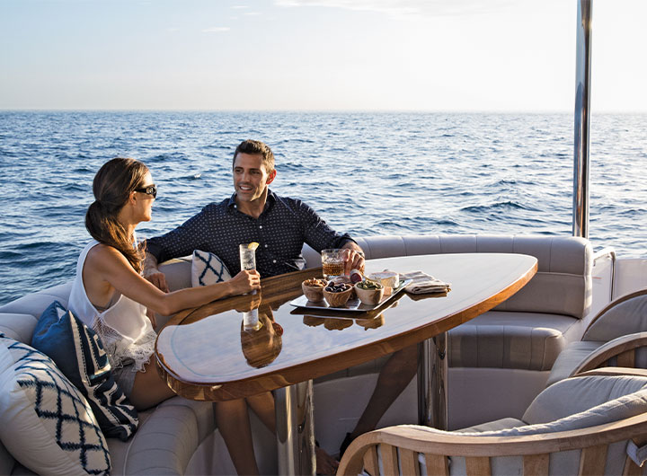 Man and Woman sitting at table on yacht