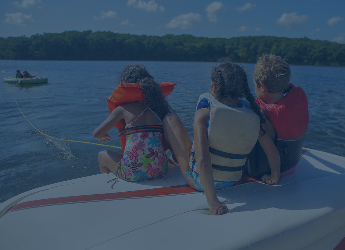Kids in life jackets with a dark overlay