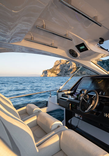 Interior of a luxurious yacht with a view of the ocean and mountains.